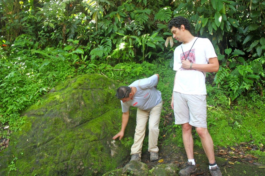 Miguel explaining the maps of Ciudad Perdida that have been carved into this rock and Santiago translating.  