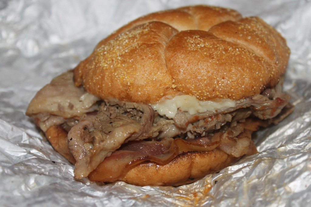 The Clogger:    hot beef brisket, provolone, bacon, gravy, and mayonnaise on a kaiser roll.