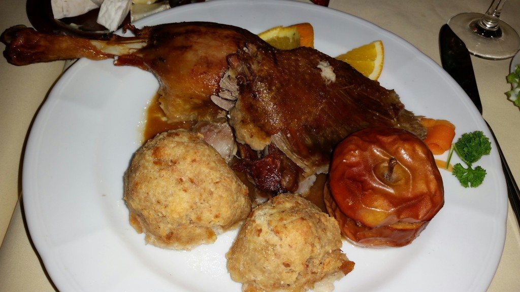 A traditional German Christmas dinner: goose with a side of stuffing, a baked apple, and sweet red cabbage (not pictured).