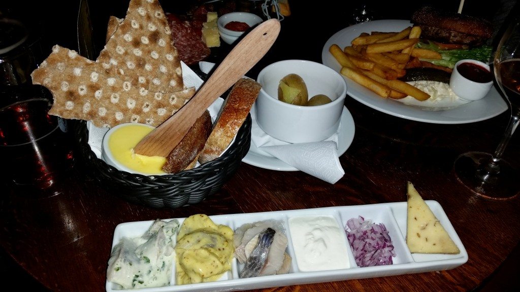 Three types of pickled herring served with crisp bread, sour cream, onions and potatoes. 