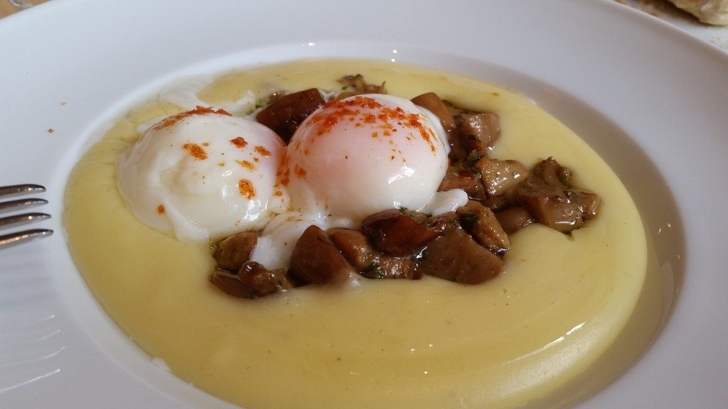 Mushrooms with soft eggs and truffle sauce over potato mash.