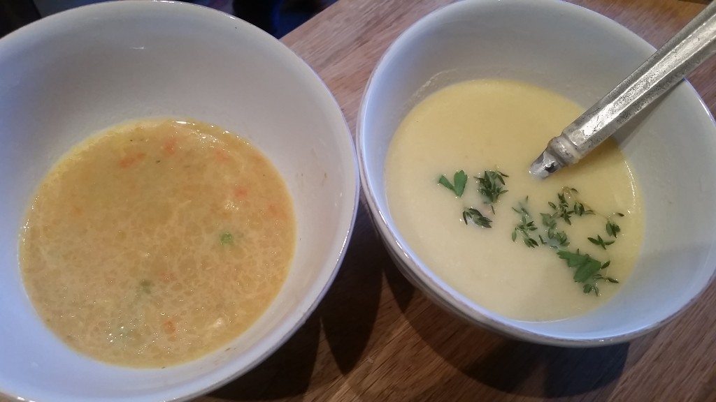 Curried chicken soup and cauliflower garlic soup with herbs