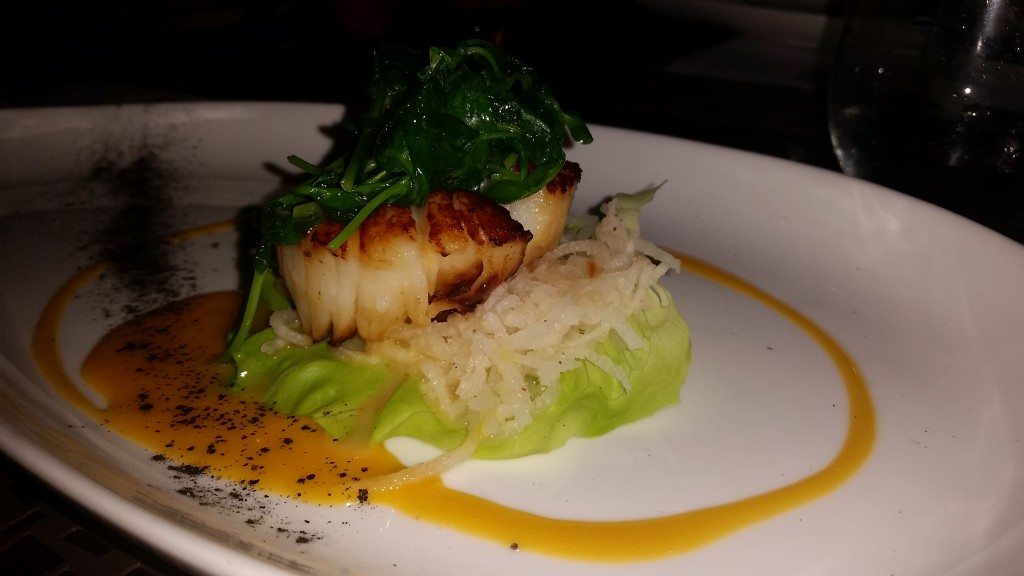 Pan-seared scallops, green pea shoots and jicama with a passion fruit sauce, paired with a Lucifer.