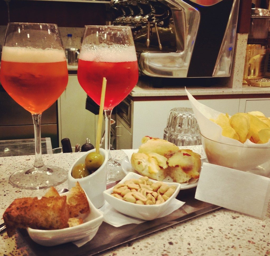 A traditional apertivo spread with comapri and aperol spritz at a Venetian bar where Vickie and I very quickly would have become locals.