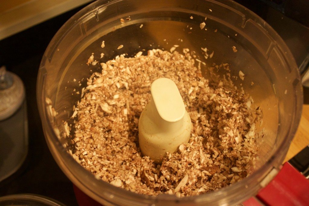 Pulse mushrooms in the bowl of a food processor.