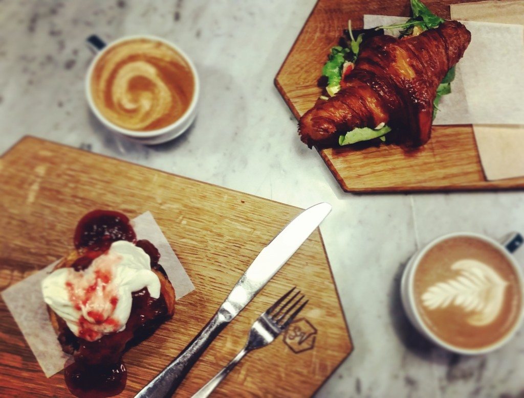 Croissant Breakfast Sandwich and a Berry & Thyme Scone with Strawberry Balsamic Jam and Clotted Cream.